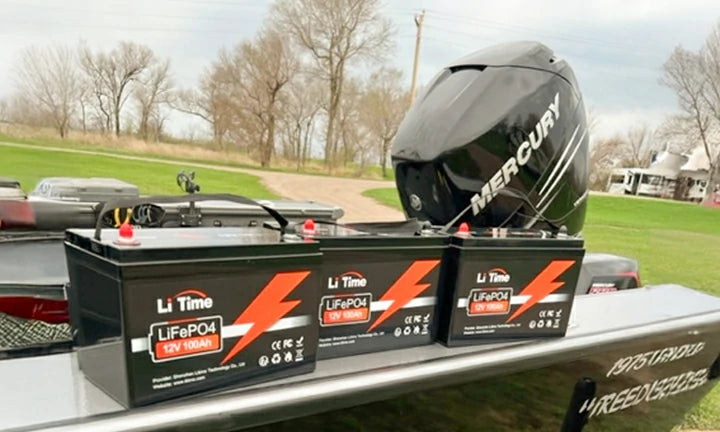3 LiTime batteries lined up on the back of a bass boat that is on a trailer